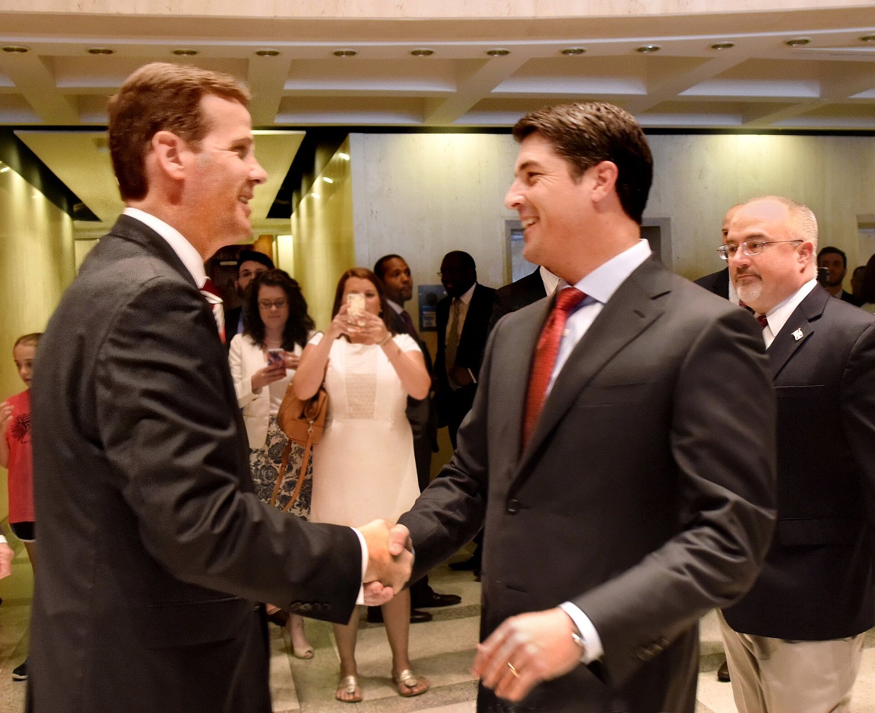 Two people shaking hands at a formal meeting